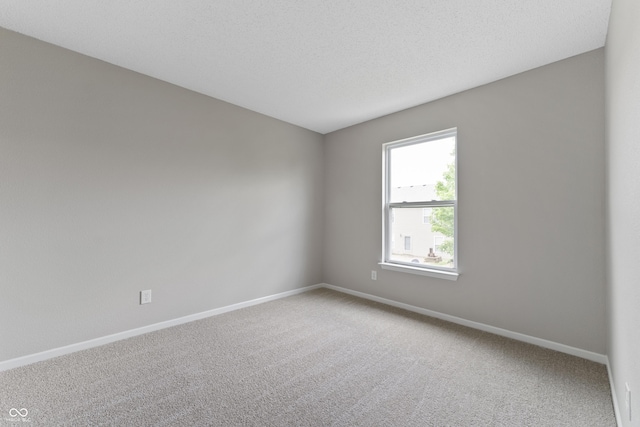 unfurnished room featuring carpet floors and baseboards