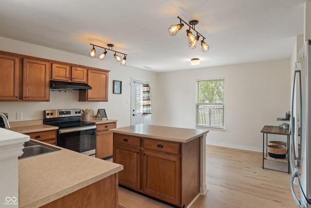 8238 Crackling Ln, Indianapolis, IN 46259 - kitchen with stainless steel electric range oven, under cabinet range hood, freestanding refrigerator, brown cabinets, and light countertops