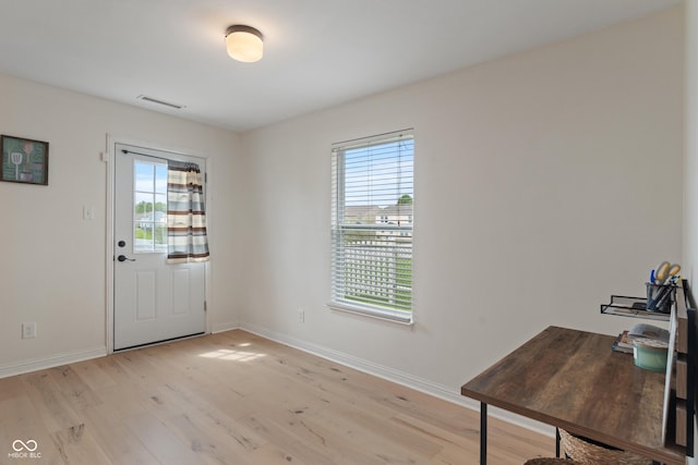 8238 Crackling Ln, Indianapolis, IN 46259 - doorway to outside featuring plenty of natural light, light wood finished floors, and baseboards