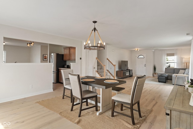 8238 Crackling Ln, Indianapolis, IN 46259 - dining room with a chandelier, light wood finished floors, and baseboards