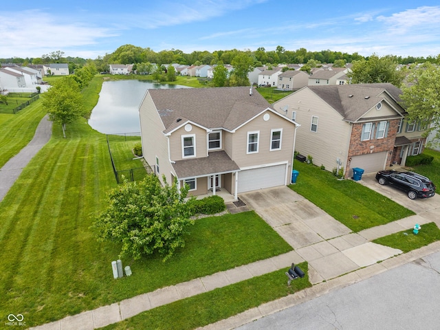 8238 Crackling Ln, Indianapolis, IN 46259 - traditional-style home with an attached garage, a residential view, driveway, a front yard, and a water view