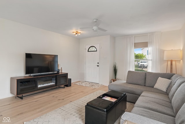 8238 Crackling Ln, Indianapolis, IN 46259 - living room with light wood finished floors, a ceiling fan, and baseboards