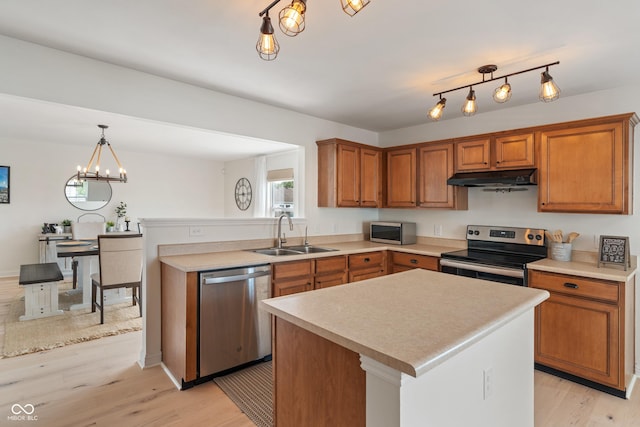 8238 Crackling Ln, Indianapolis, IN 46259 - kitchen with stainless steel appliances, a sink, under cabinet range hood, and brown cabinetry