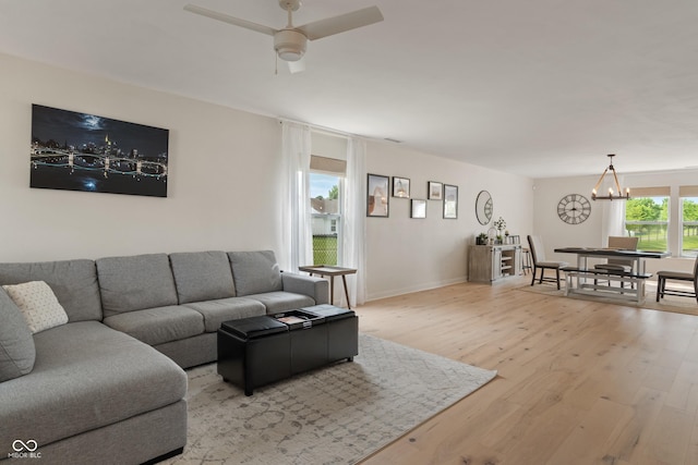 8238 Crackling Ln, Indianapolis, IN 46259 - living room with a chandelier, wood finished floors, ceiling fan, and baseboards
