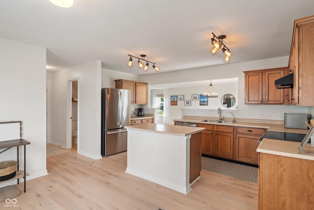 8238 Crackling Ln, Indianapolis, IN 46259 - kitchen featuring range hood, stainless steel appliances, a sink, light wood-style flooring, and light countertops