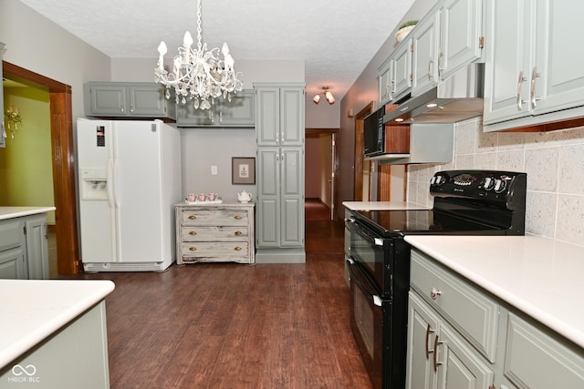 6567 Kings Ct, Avon, IN 46123 - kitchen with black appliances, light countertops, dark wood-type flooring, under cabinet range hood, and decorative backsplash