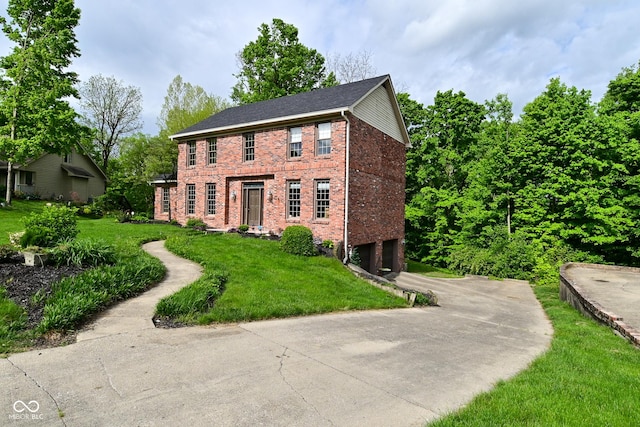 6567 Kings Ct, Avon, IN 46123 - colonial-style house featuring an attached garage, driveway, brick siding, and a front yard