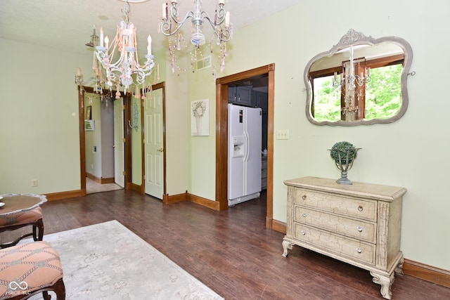 6567 Kings Ct, Avon, IN 46123 - sitting room with a chandelier and dark wood finished floors