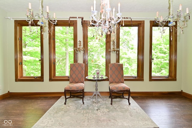 6567 Kings Ct, Avon, IN 46123 - living area featuring a chandelier, wood finished floors, and healthy amount of natural light