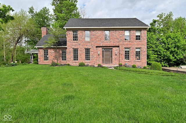 6567 Kings Ct, Avon, IN 46123 - colonial home featuring a chimney, a front lawn, brick siding, and a shingled roof