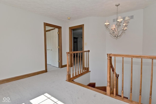 6567 Kings Ct, Avon, IN 46123 - staircase featuring carpet floors, a chandelier, and a textured ceiling