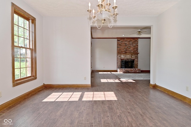6567 Kings Ct, Avon, IN 46123 - unfurnished living room with wood finished floors, plenty of natural light, ceiling fan, and a chandelier