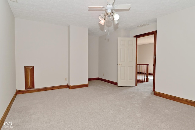 6567 Kings Ct, Avon, IN 46123 - unfurnished room with light carpet, a ceiling fan, and a textured ceiling