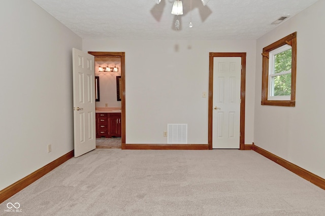 6567 Kings Ct, Avon, IN 46123 - unfurnished bedroom with light carpet, a textured ceiling, and ensuite bath