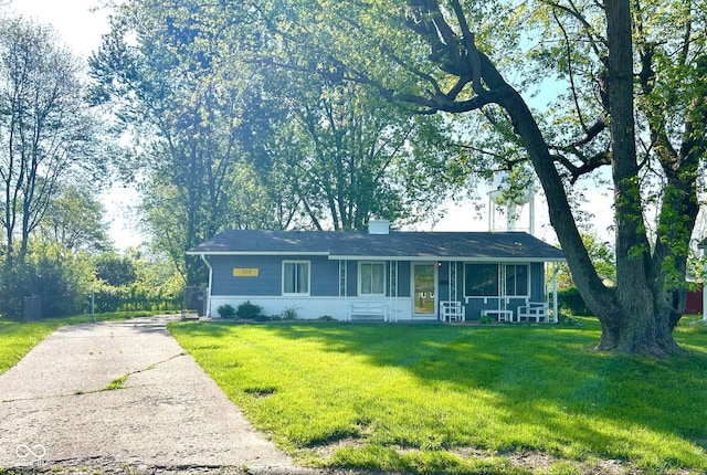 ranch-style house with asphalt driveway, a front yard, and a sunroom