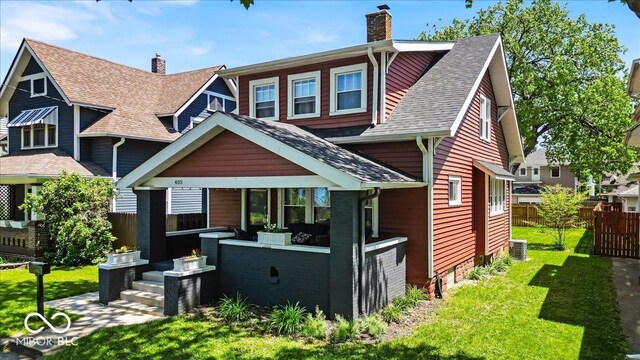 405 N Drexel Ave, Indianapolis, IN 46201 - view of front facade featuring a chimney, a shingled roof, and cooling unit