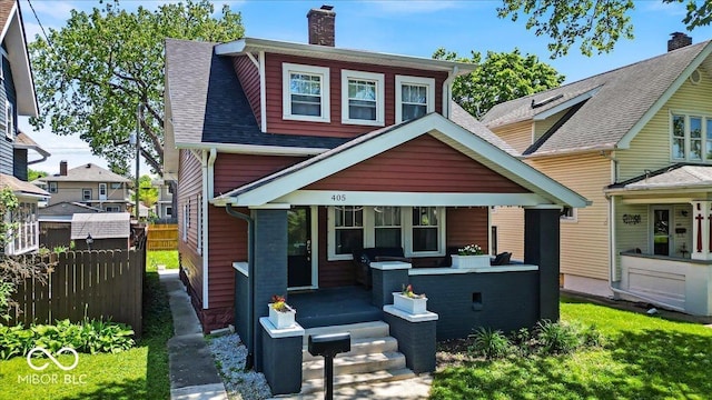 405 N Drexel Ave, Indianapolis, IN 46201 - rear view of property with fence, a chimney, covered porch, and roof with shingles