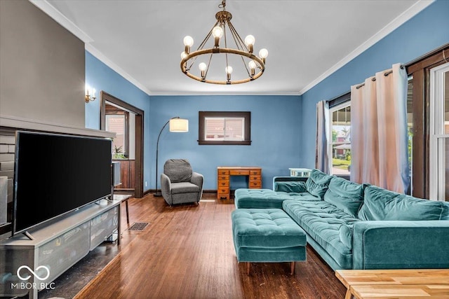 405 N Drexel Ave, Indianapolis, IN 46201 - living room featuring a chandelier, wood finished floors, crown molding, and baseboards