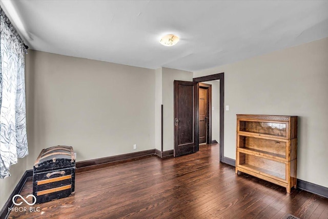 405 N Drexel Ave, Indianapolis, IN 46201 - unfurnished bedroom with dark wood-style floors, baseboards, and multiple windows