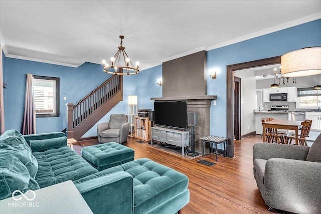 405 N Drexel Ave, Indianapolis, IN 46201 - living area with a chandelier, crown molding, plenty of natural light, wood finished floors, and stairway