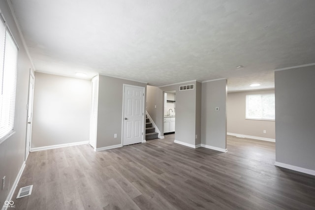 2740 Pawnee Dr, Indianapolis, IN 46229 - spare room with stairs, baseboards, dark wood-style floors, and a sink