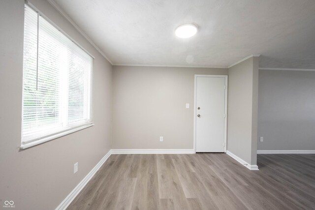 2740 Pawnee Dr, Indianapolis, IN 46229 - unfurnished room featuring wood finished floors, baseboards, and crown molding