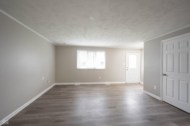 2740 Pawnee Dr, Indianapolis, IN 46229 - spare room with crown molding, baseboards, wood finished floors, and a textured ceiling