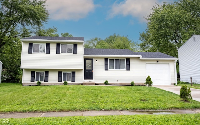 2740 Pawnee Dr, Indianapolis, IN 46229 - tri-level home featuring an attached garage, concrete driveway, and a front yard