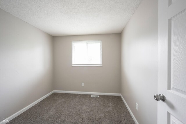 2740 Pawnee Dr, Indianapolis, IN 46229 - carpeted empty room featuring a textured ceiling and baseboards