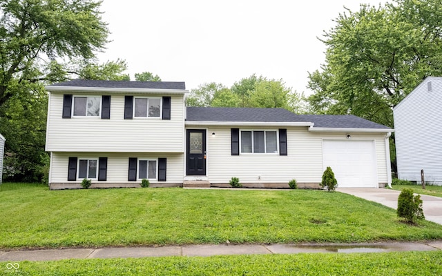 2740 Pawnee Dr, Indianapolis, IN 46229 - tri-level home featuring an attached garage, driveway, and a front yard
