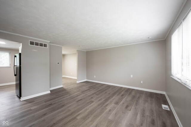 2740 Pawnee Dr, Indianapolis, IN 46229 - spare room with baseboards, dark wood-style floors, and crown molding