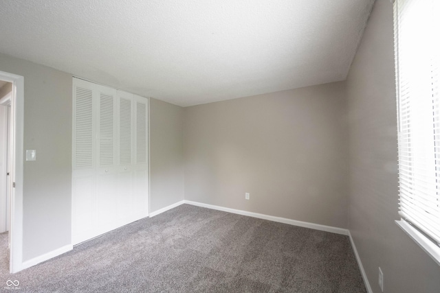 2740 Pawnee Dr, Indianapolis, IN 46229 - unfurnished bedroom featuring carpet floors, a closet, and baseboards