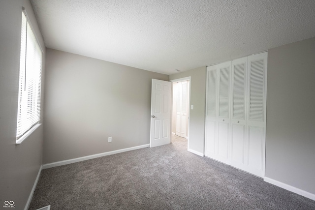 2740 Pawnee Dr, Indianapolis, IN 46229 - unfurnished bedroom with carpet floors, a textured ceiling, baseboards, and a closet