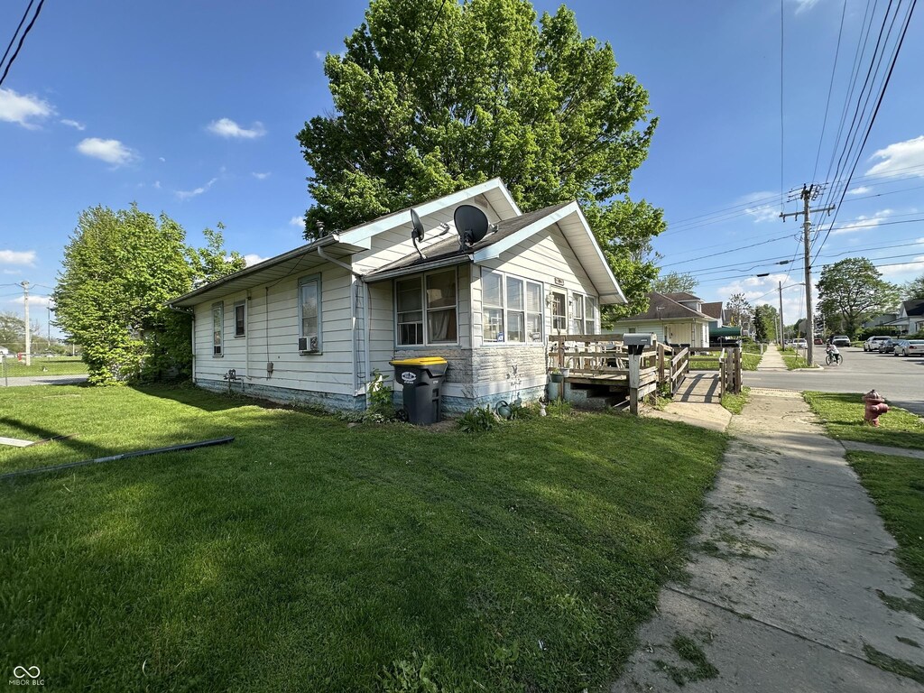 1830 Jefferson St, Anderson, IN 46016 - view of property exterior with a lawn, a deck, and cooling unit