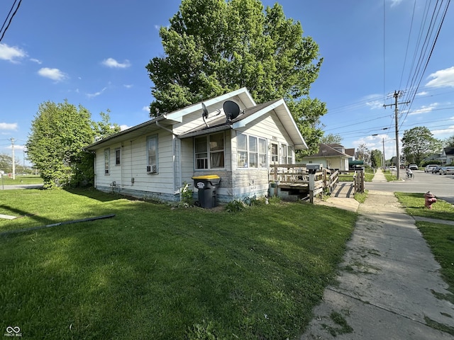 1830 Jefferson St, Anderson, IN 46016 - view of property exterior with a lawn, a deck, and cooling unit