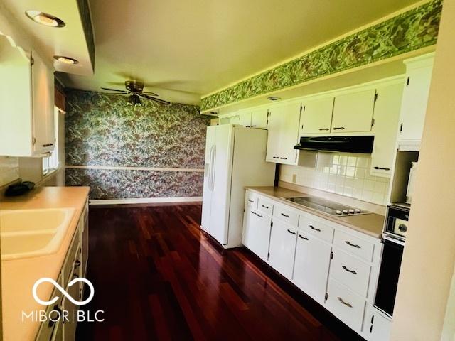 5141 Derome Dr, Fort Wayne, IN 46835 - kitchen with black appliances, wallpapered walls, a ceiling fan, a sink, and dark wood-style floors