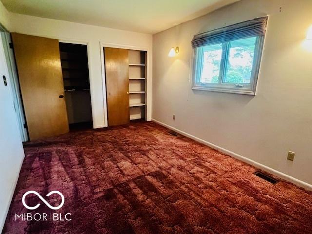 5141 Derome Dr, Fort Wayne, IN 46835 - unfurnished bedroom with multiple closets, baseboards, and carpet flooring