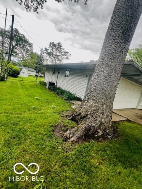 5141 Derome Dr, Fort Wayne, IN 46835 - view of side of property featuring a yard and a garage