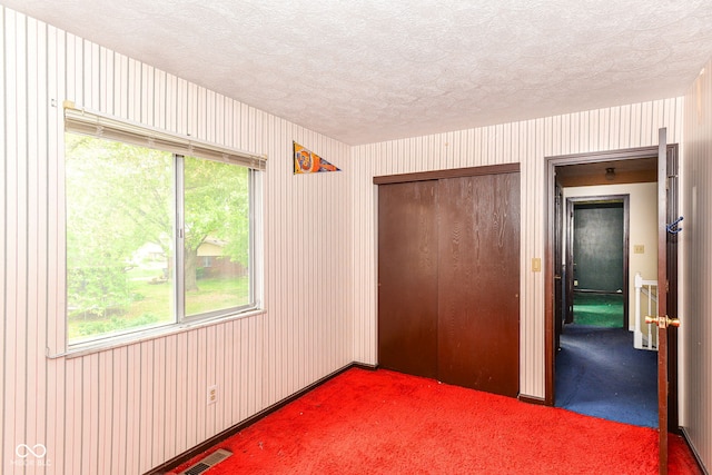 3325 Broadview Ct, Indianapolis, IN 46227 - unfurnished bedroom featuring a textured ceiling, a closet, and carpet