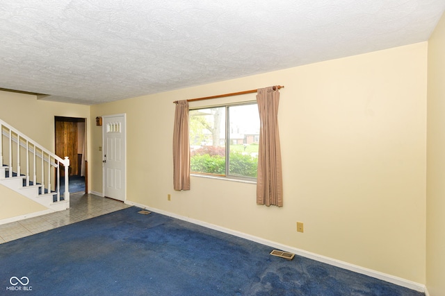 3325 Broadview Ct, Indianapolis, IN 46227 - carpeted empty room featuring stairway, a textured ceiling, and baseboards
