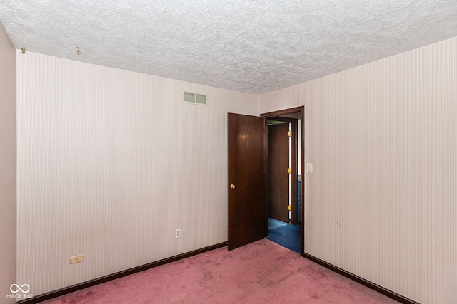 3325 Broadview Ct, Indianapolis, IN 46227 - spare room with a textured ceiling, carpet flooring, and baseboards