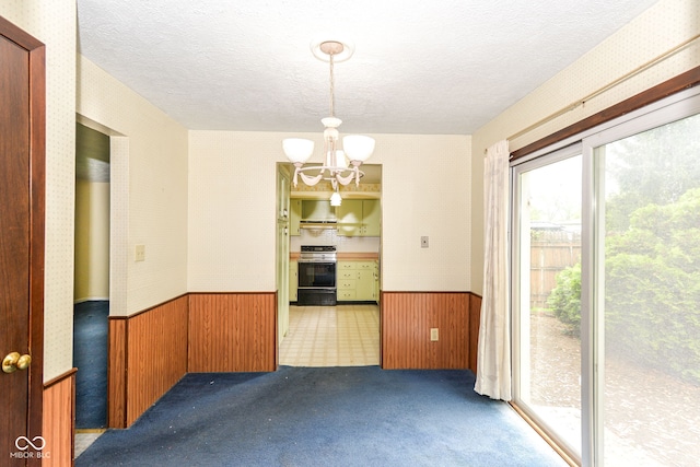 3325 Broadview Ct, Indianapolis, IN 46227 - spare room featuring a wainscoted wall, a chandelier, a textured ceiling, wood walls, and carpet floors