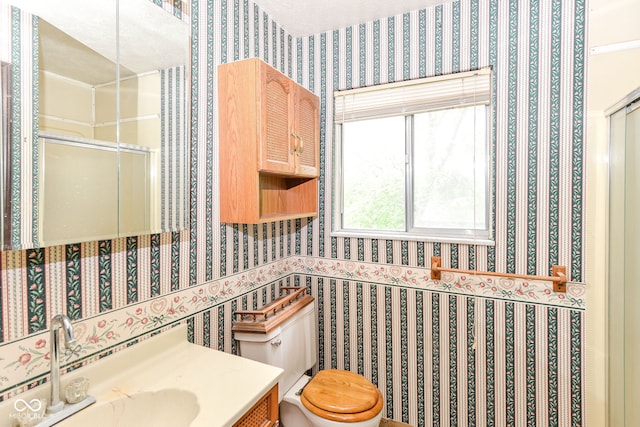 3325 Broadview Ct, Indianapolis, IN 46227 - bathroom with wallpapered walls, toilet, a stall shower, vanity, and wainscoting