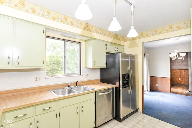 3325 Broadview Ct, Indianapolis, IN 46227 - kitchen featuring appliances with stainless steel finishes, a sink, light flooring, a chandelier, and a wainscoted wall