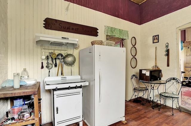 2490 S County Road 60 E, Greensburg, IN 47240 - kitchen with freestanding refrigerator, wood finished floors, under cabinet range hood, and wood walls