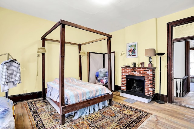 2490 S County Road 60 E, Greensburg, IN 47240 - bedroom with wood-type flooring, a fireplace, and baseboards