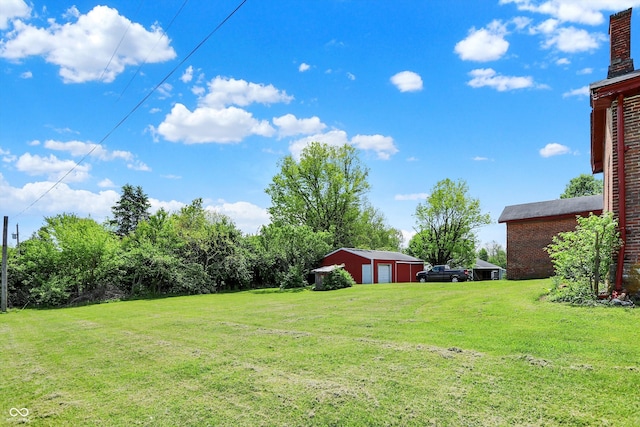 2490 S County Road 60 E, Greensburg, IN 47240 - view of green lawn featuring a detached garage and an outbuilding