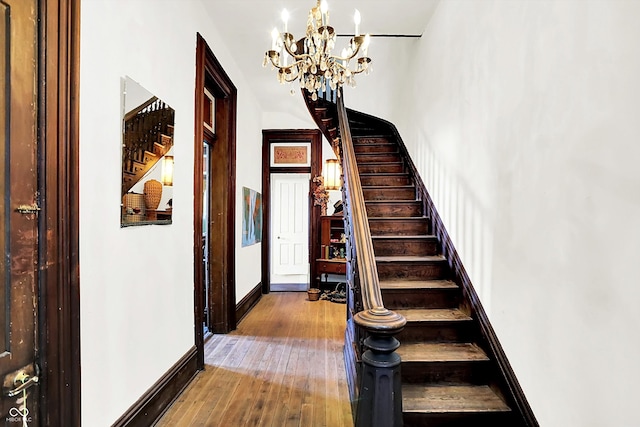2490 S County Road 60 E, Greensburg, IN 47240 - stairs with a chandelier, baseboards, hardwood / wood-style flooring, and a high ceiling
