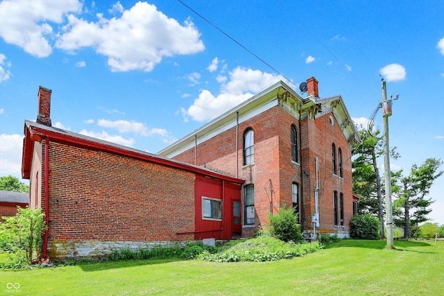 2490 S County Road 60 E, Greensburg, IN 47240 - view of property exterior featuring brick siding, a chimney, and a lawn