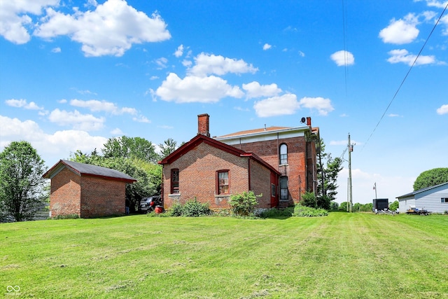 2490 S County Road 60 E, Greensburg, IN 47240 - rear view of house featuring brick siding, a chimney, and a yard